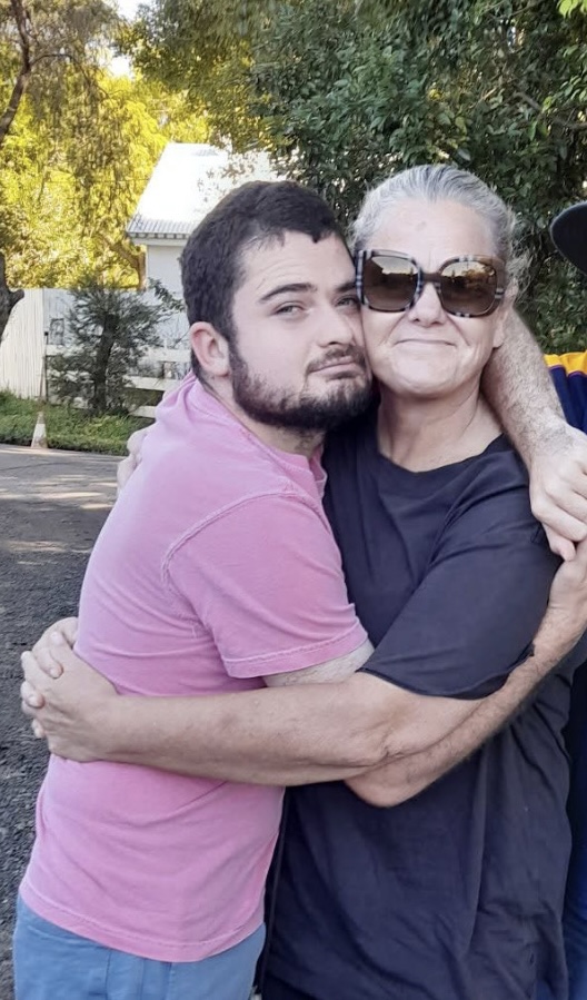 Will and his mum Kris, holding each other close and smiling.